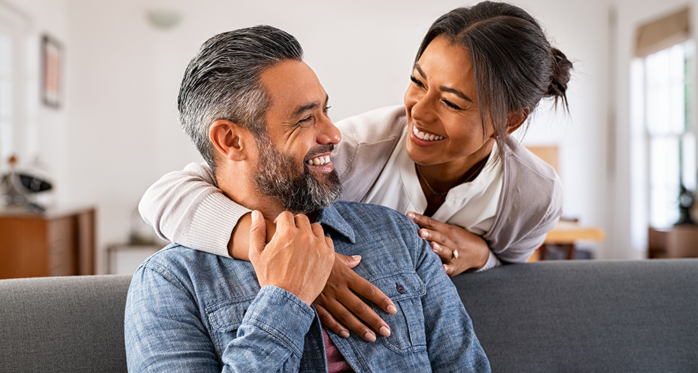 Couple smiling and embracing. 