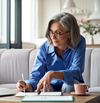 Woman writing her expenses while working on her budget. 