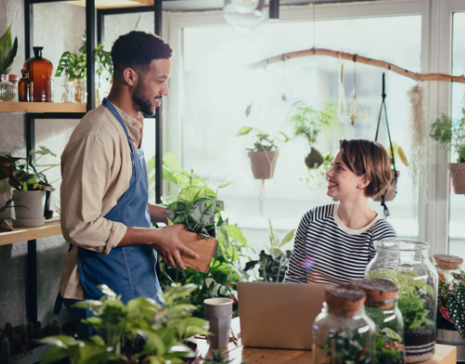 Two plant store team members having a conversation. 