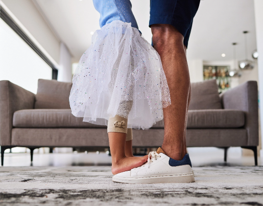 A family dances in a living room