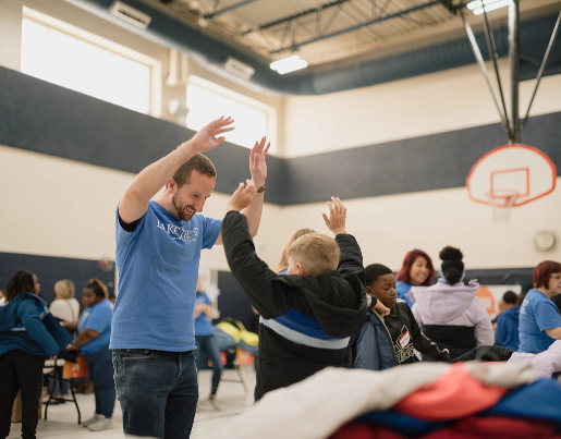 A Lake Trust team member holds his hands in the air