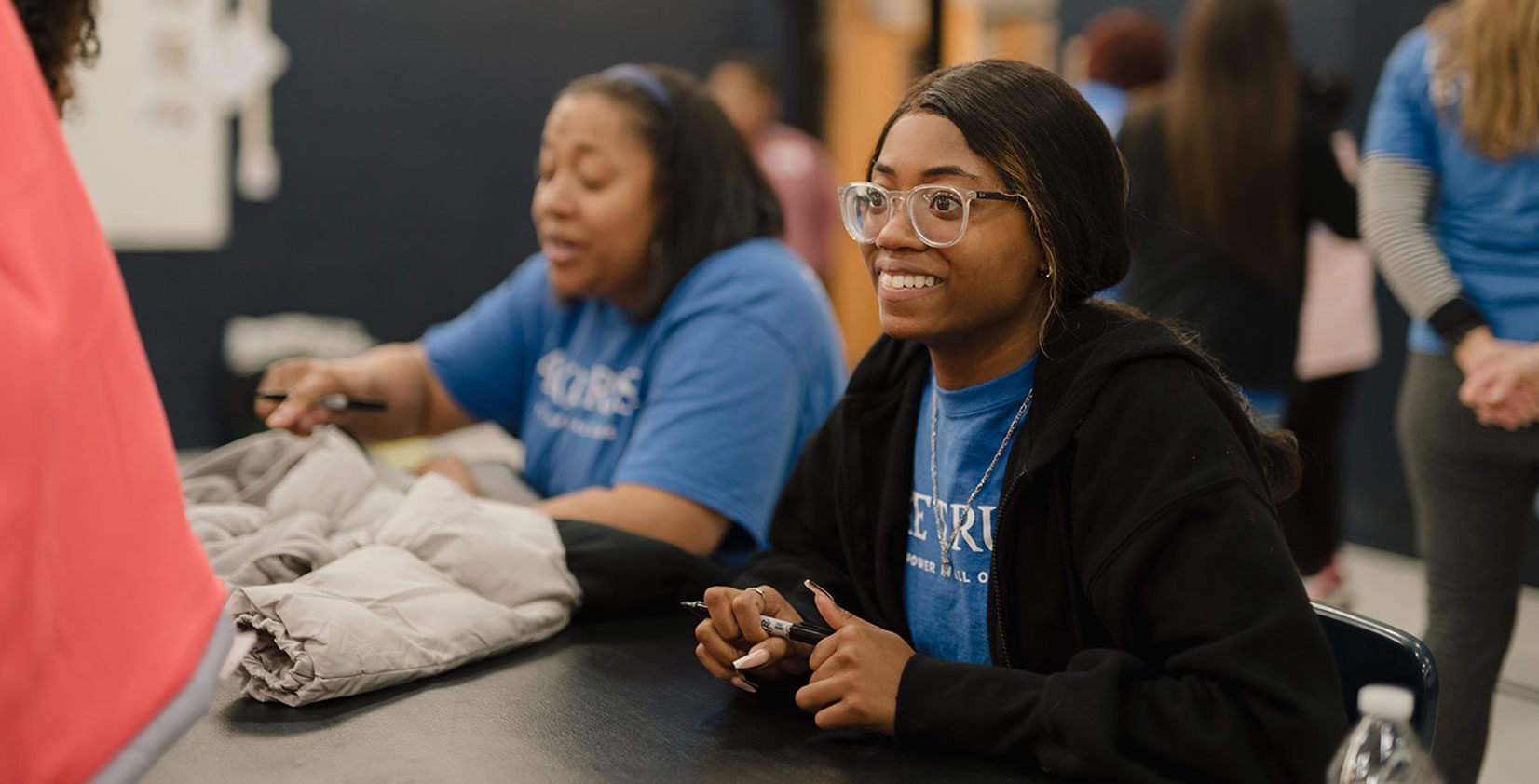 A Lake Trust team member smiles at a volunteer event