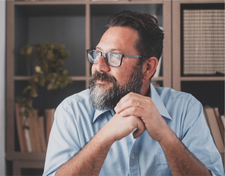 Bearded man staring off into the distance. 