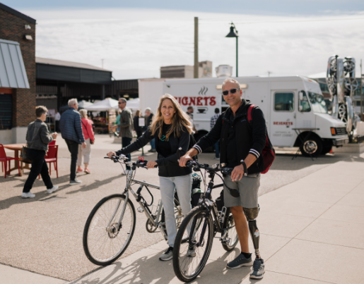 Kim and Chris, the owners of Anew Life Prosthetics and Orthotics, ride their bikes at Eastern Market