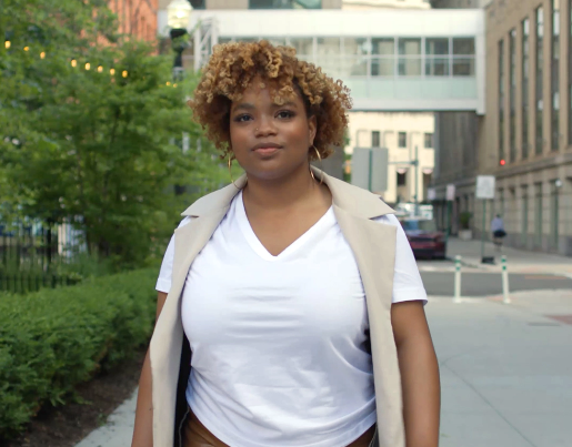 Autumn, the owner of Proxie, walks down a street in Detroit