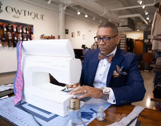 Business owner, Ne'gyle, sewing bowties.