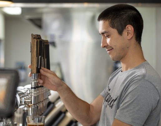 Nick, the owner of Tapped Coffee, pours a nitro cold brew coffee