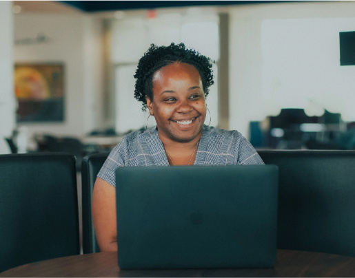 LaToya, a 2019 Lake Trust Foundation Scholarship recipient, smiles and looks at a laptop