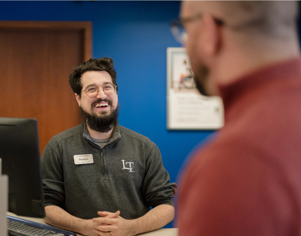 A Lake Trust team member laughs in a branch 