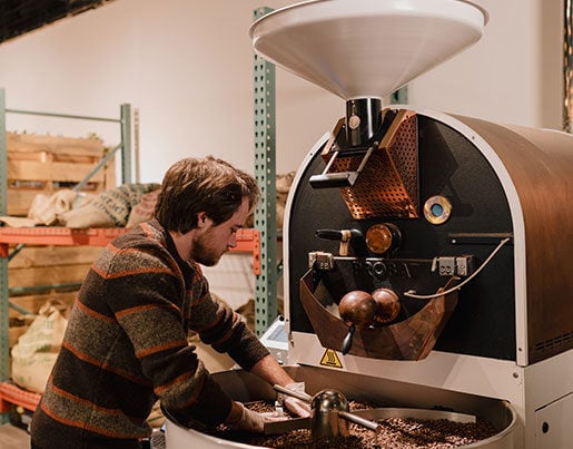 Owner of Brighton Coffeehouse, Spencer, roasting coffee beans