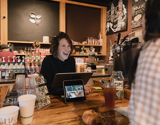 Amy, owner of Brighton Coffeehouse taking a customer's order