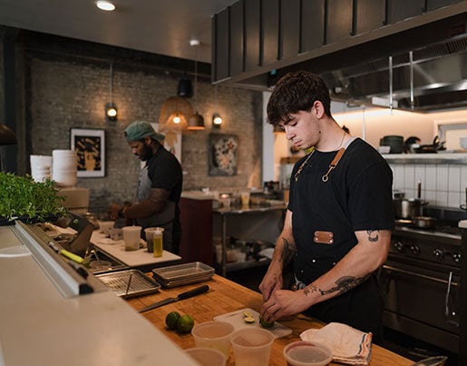 Two Freya employees preparing food