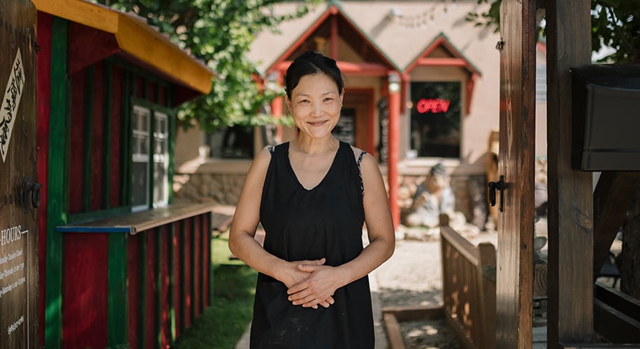 Maya, owner of Jib Bob, standing in front of her restaurant