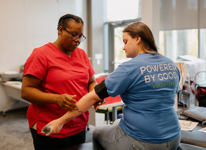 A lake trust volunteer donating blood.