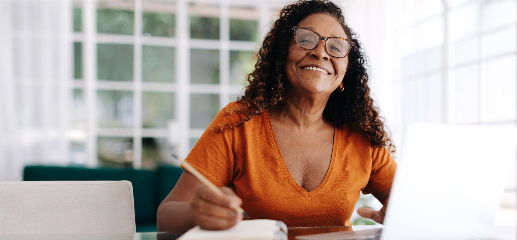 Smiling woman with notepad and pencil.