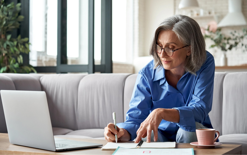 Woman writing her expenses while working on her budget. 