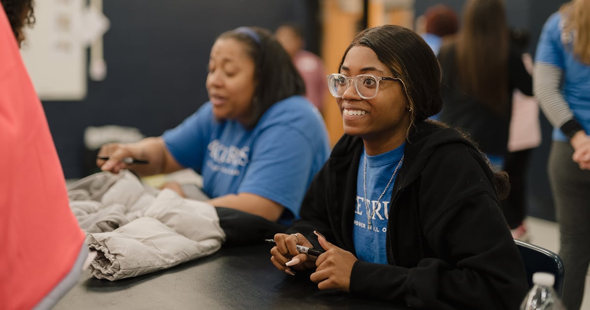 A Lake Trust team member smiles at a volunteer event