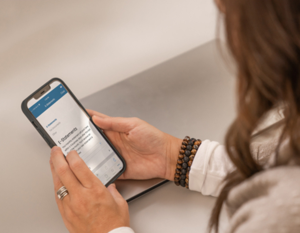 A woman checks her E-Statements on the Lake Trust mobile banking app