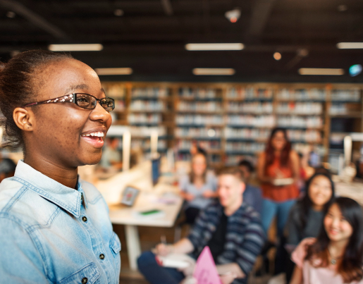 Student smiling in front of class