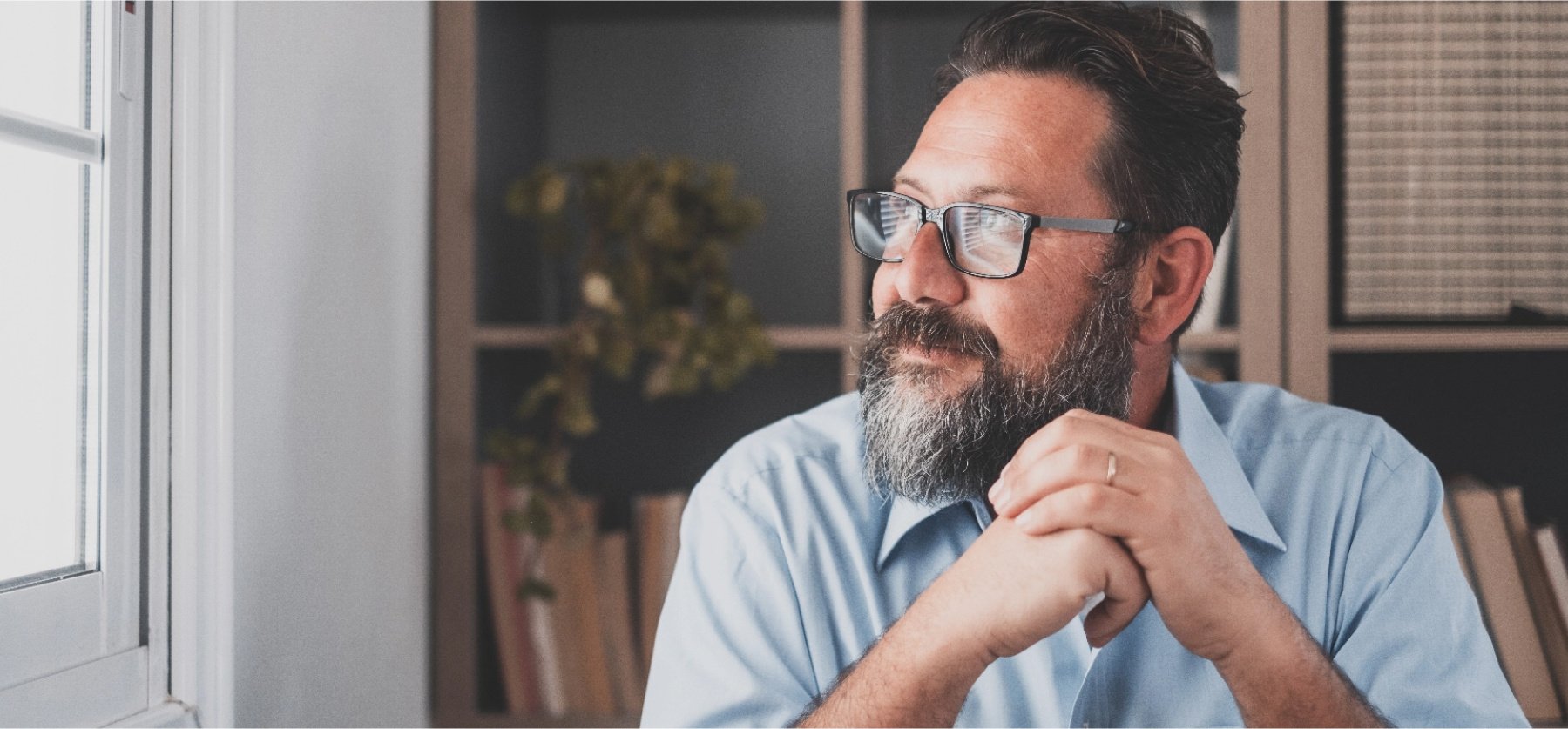 Bearded man staring off into the distance. 