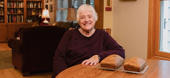 Lake Trust member, Georgia, sitting at her kitchen table