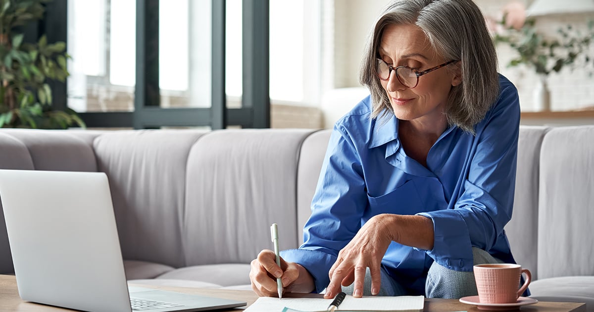 Woman writing her expenses while working on her budget. 