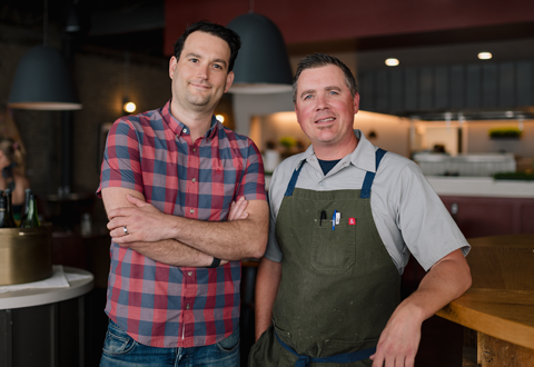 Sandy and Doug standing in their restaurant, Freya. 