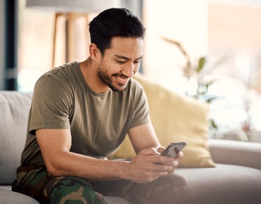 Young man on couch using Lake Trust calculators on couch. 