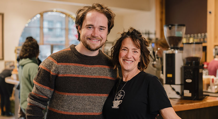 Amy and Spencer, Owners of Brighton Coffeehouse, hugging and smiling