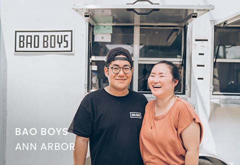 Brian, a Lake Trust business member who owns Bao Boys, stands in front of his food truck with his wife