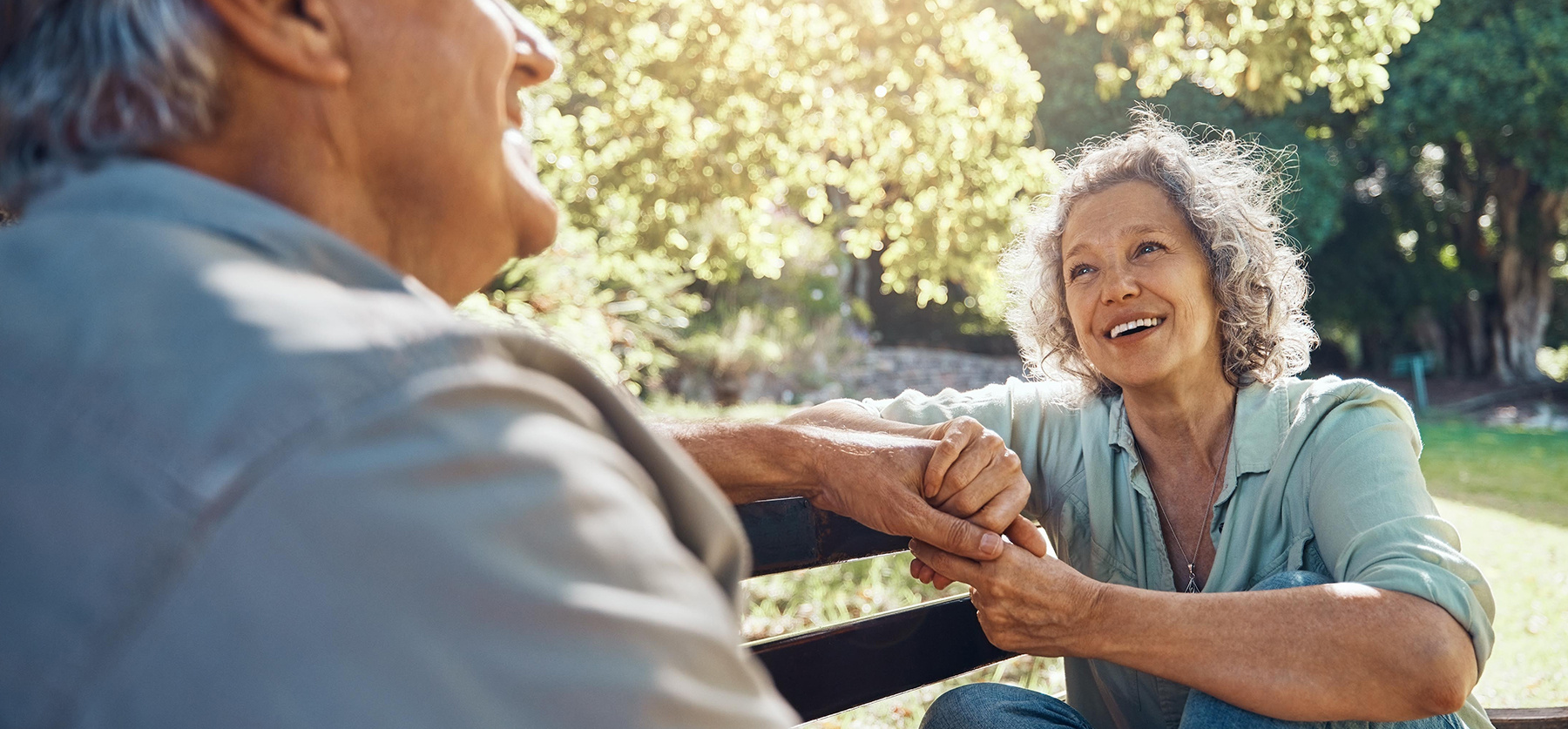 Older couple sitting on park bench.