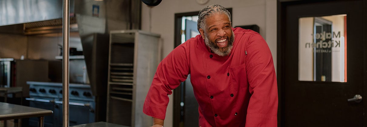 Mr. Leslie Cheesecakes owner, Marcus Leslie, smiling in his kitchen