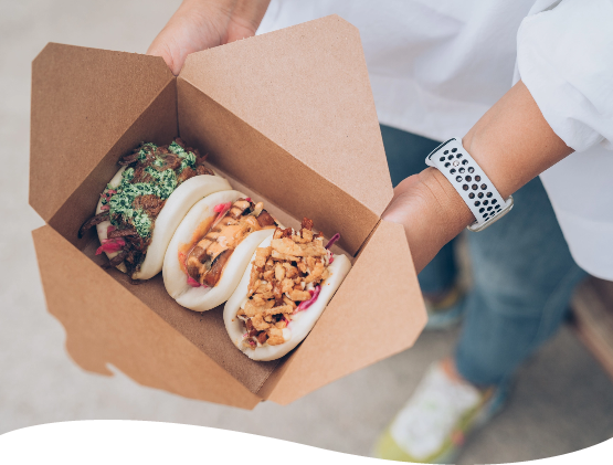 Open takeout container with three baos from Bao Boys Food Truck in Ann Arbor Michigan