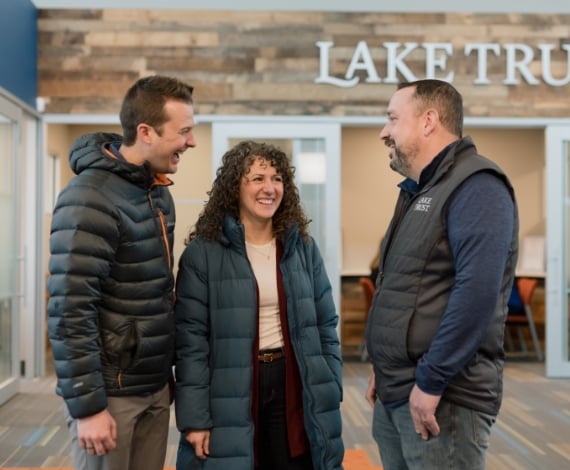 Corey, a Lake Trust member, and his wife speak to a Lake Trust team member in a branch