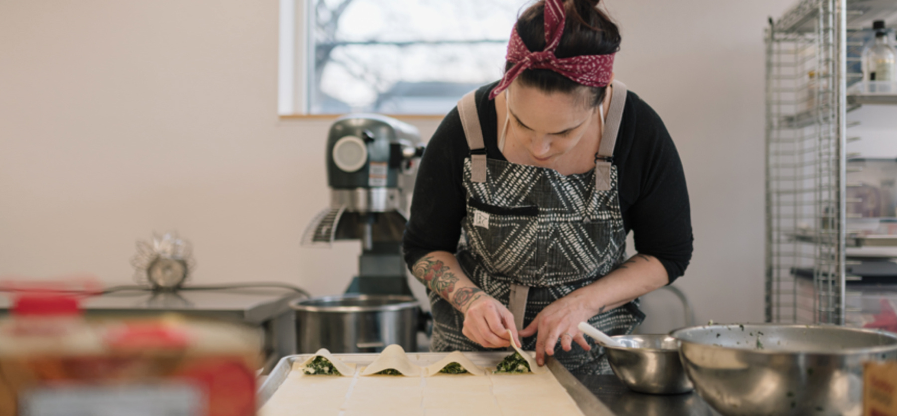 Small business owner making ravioli in incubator kitchen.