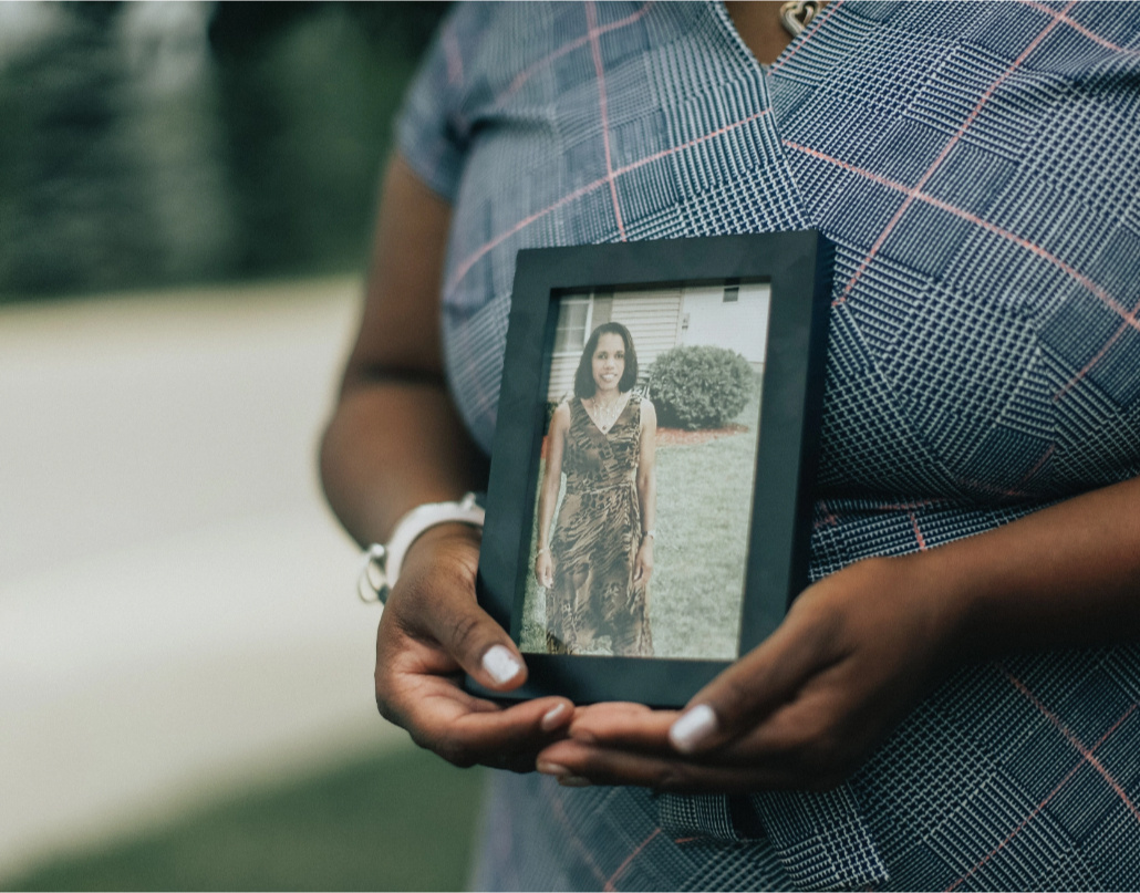 LaToya holds up a photo of her aunt who inspired her to apply for a scholarship