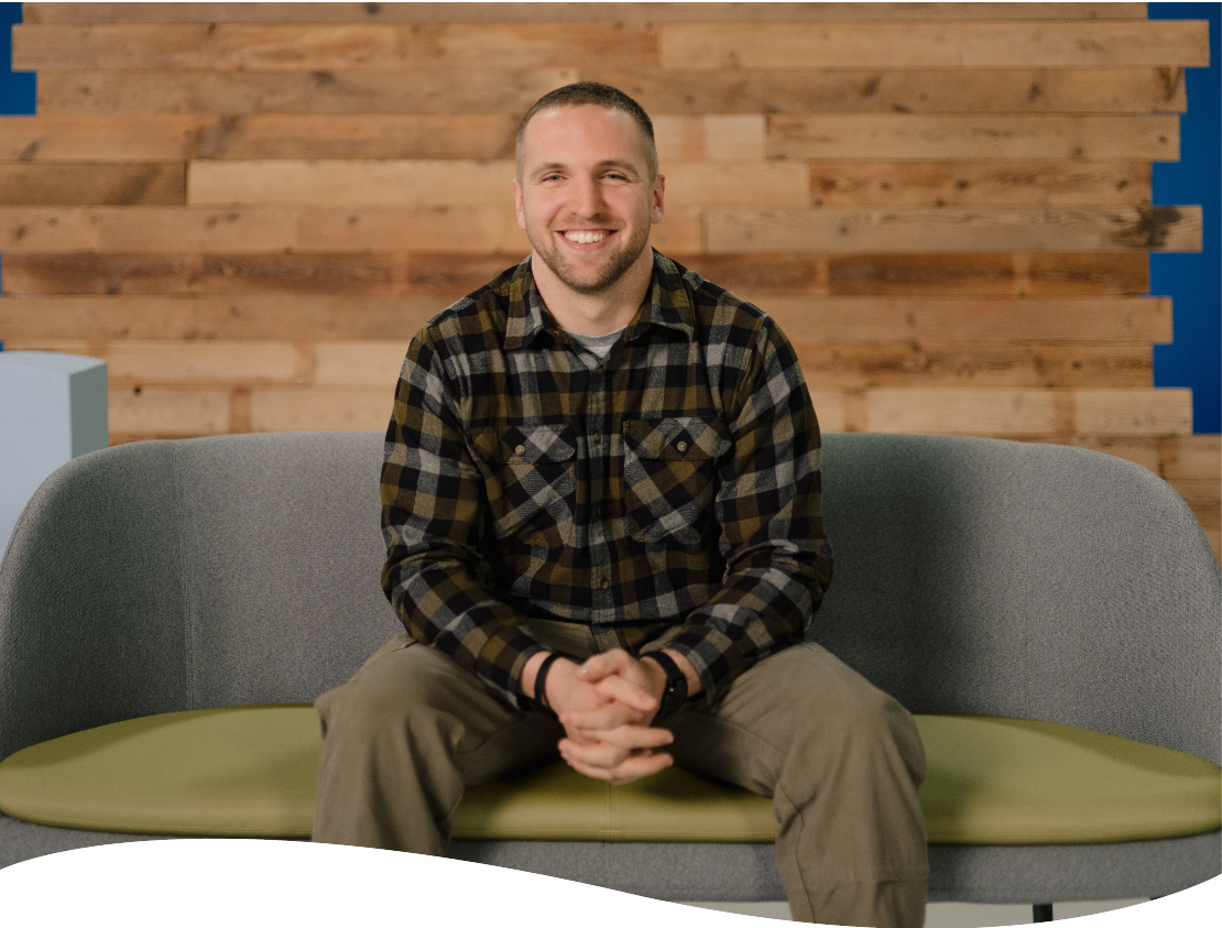 Colton, owner of Hometown Plumbing sitting on a couch